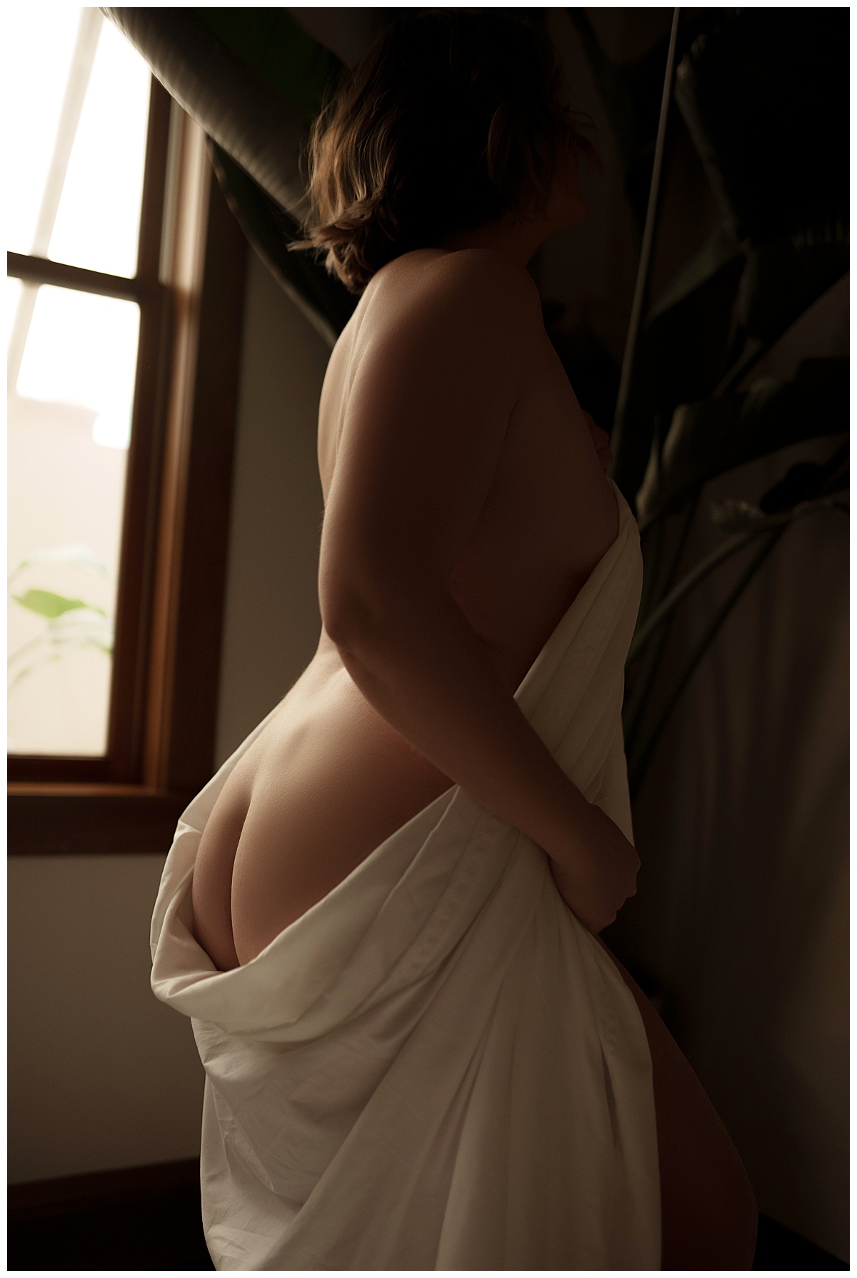 Person wraps her lower body in a white sheet for Emma Christine Photography