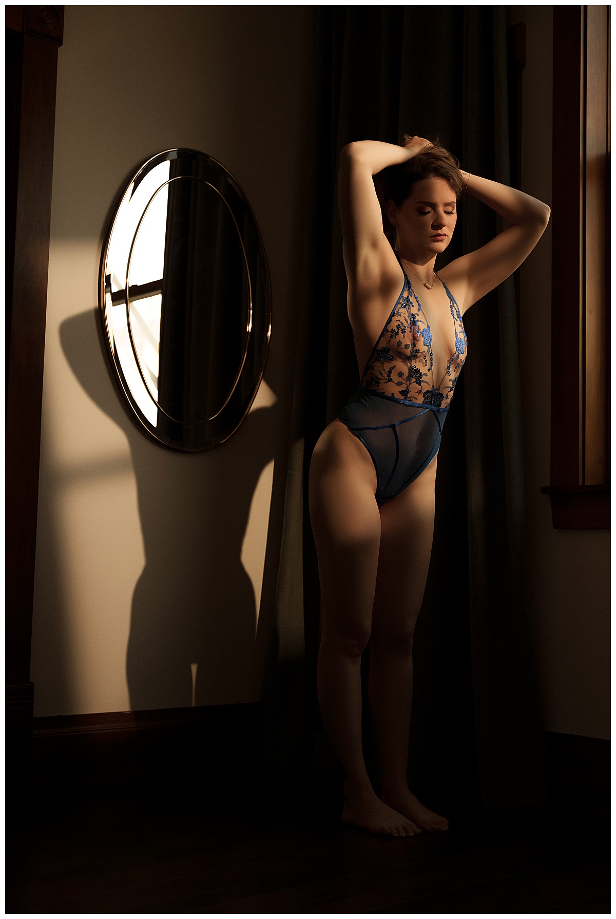 Woman wears colorful lingerie and stands in front of the mirror showing how you can Fall In Love With Yourself when you book a boudoir session