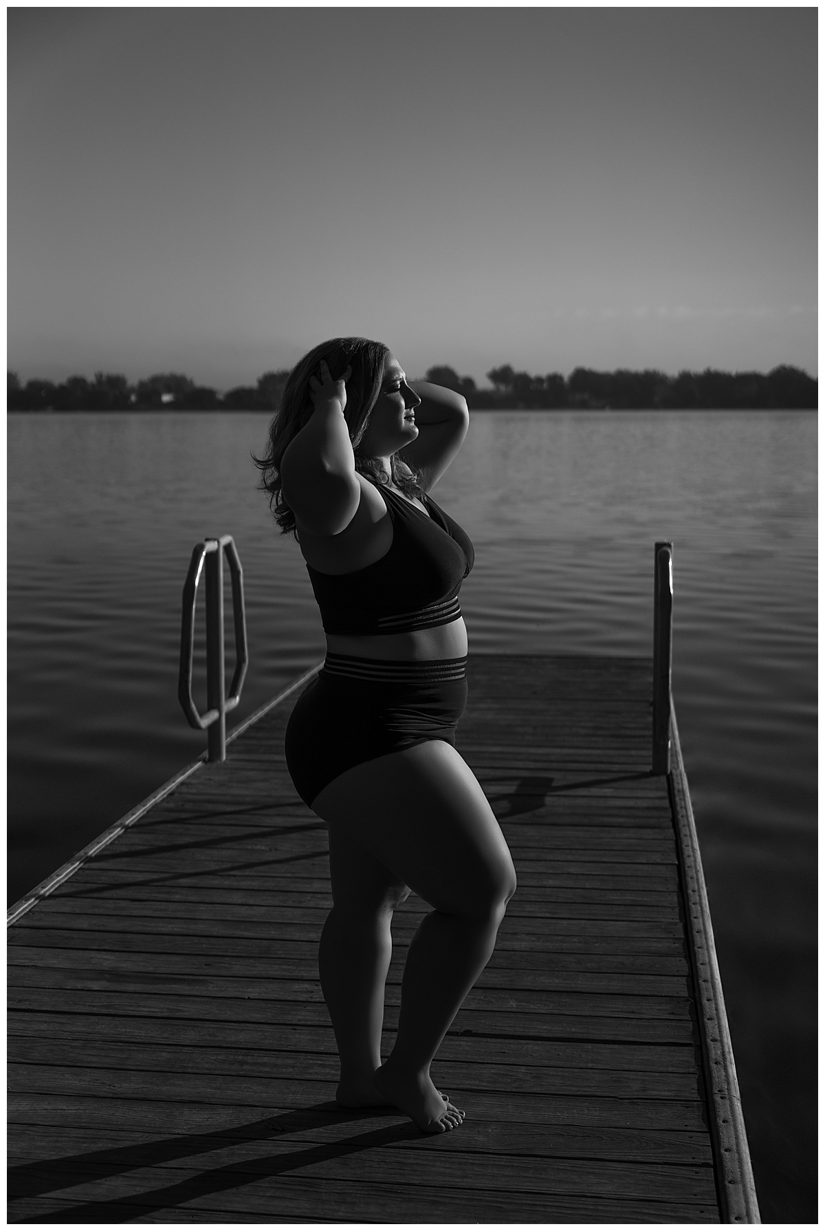 Adult runs her fingers through her hair during a Lakeside Boudoir session