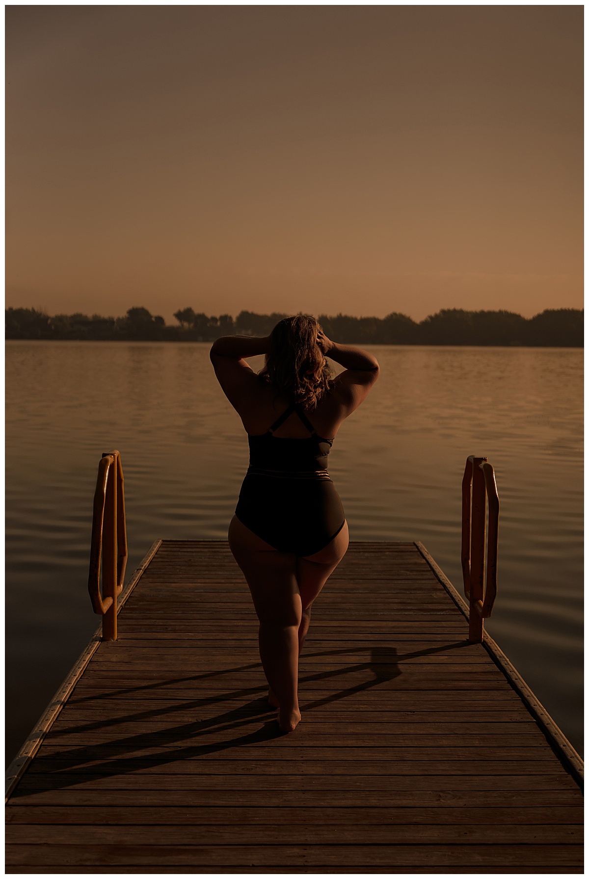 Woman walks towards the water for Sioux Falls Boudoir Photographer