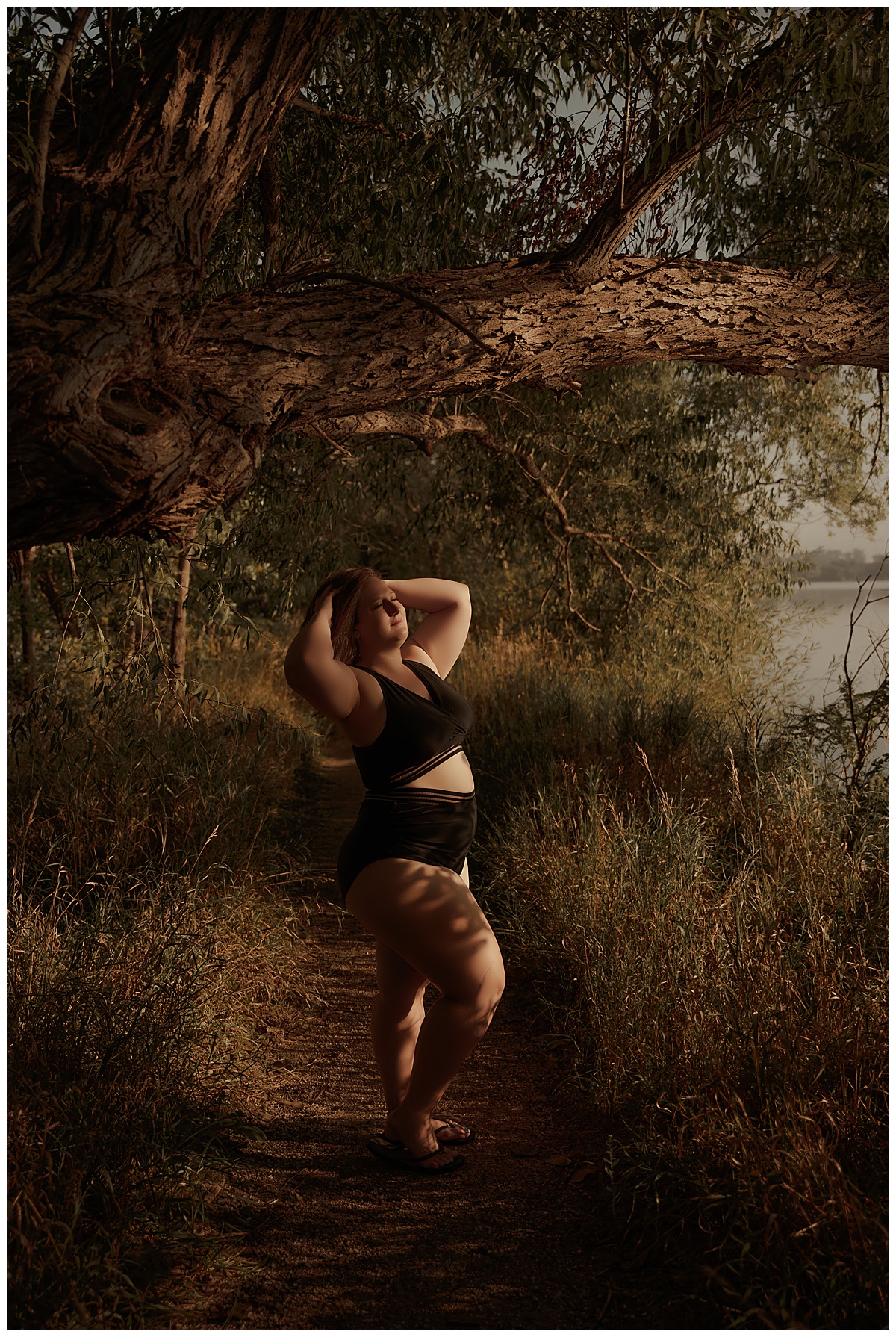 Woman stands under a tree wearing a bathing suit for Emma Christine Photography