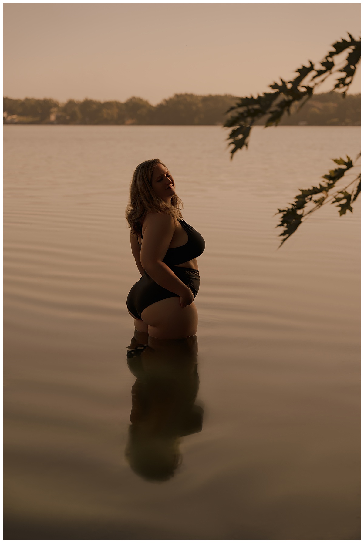 Adult stands in the water wearing a bathing suit for Sioux Falls Boudoir Photographer