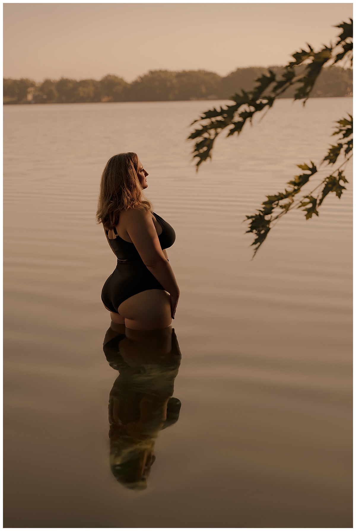 A female stands in the water wearing a bathing suit for Emma Christine Photography