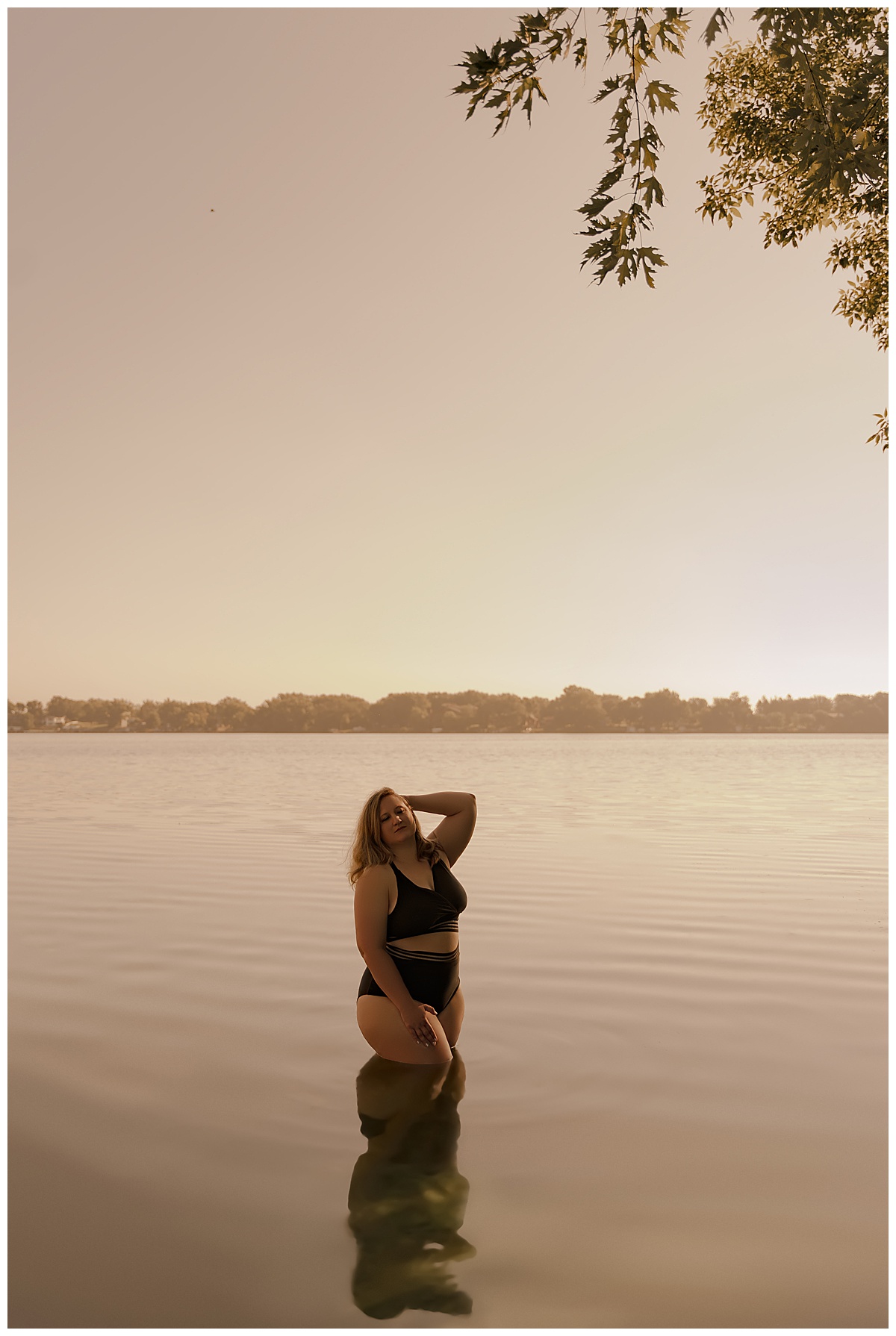 Woman holds her hand behind her head during a Lakeside Boudoir session