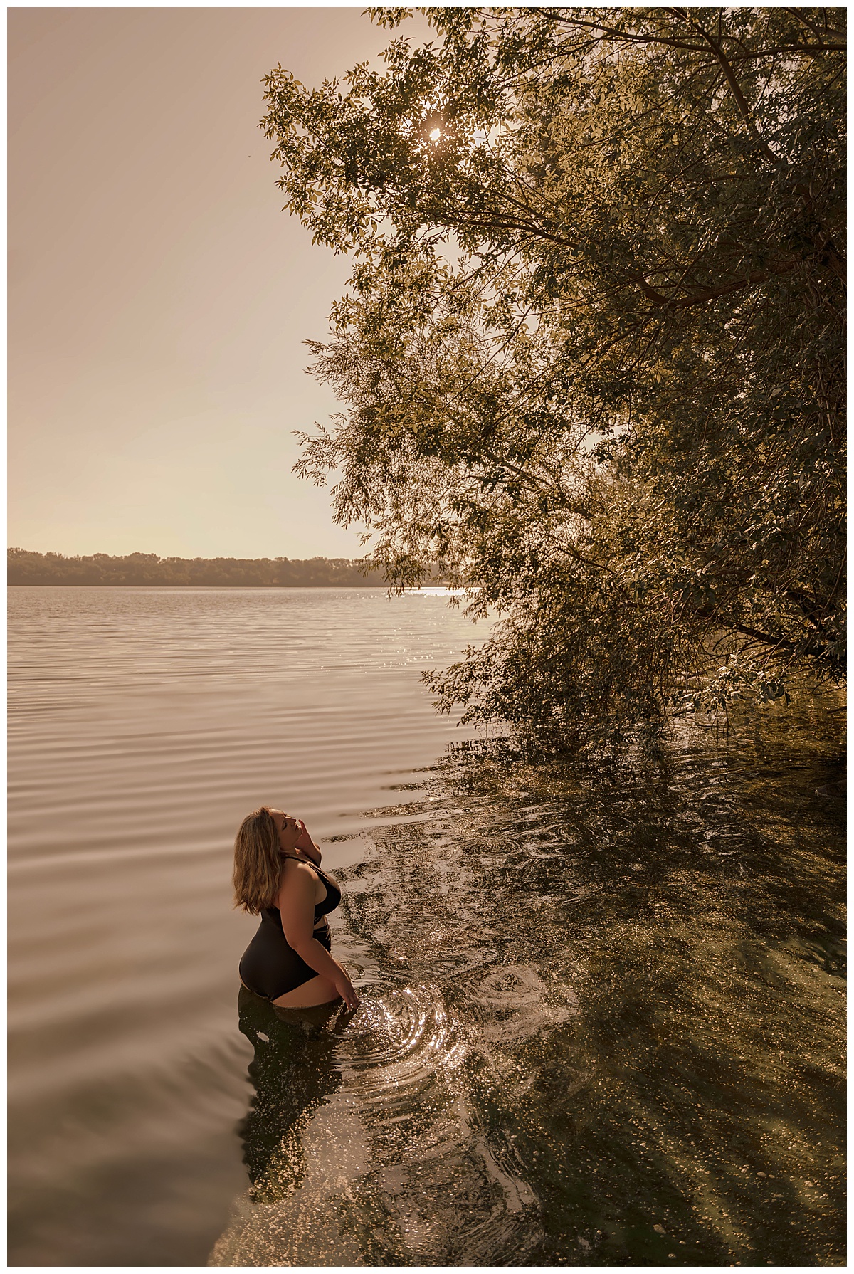 Woman stands in the water beside the trees for Sioux Falls Boudoir Photographer