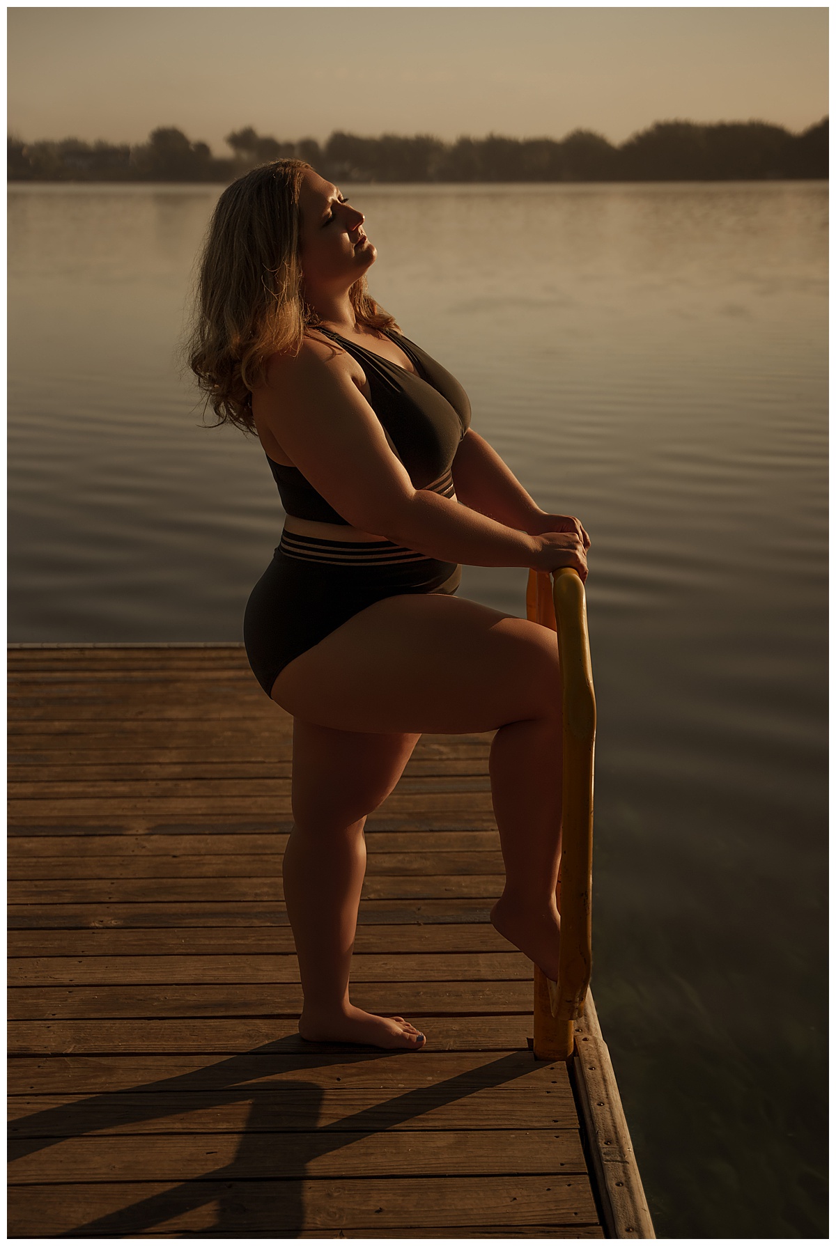 Female stands on a dock during a Lakeside Boudoir session