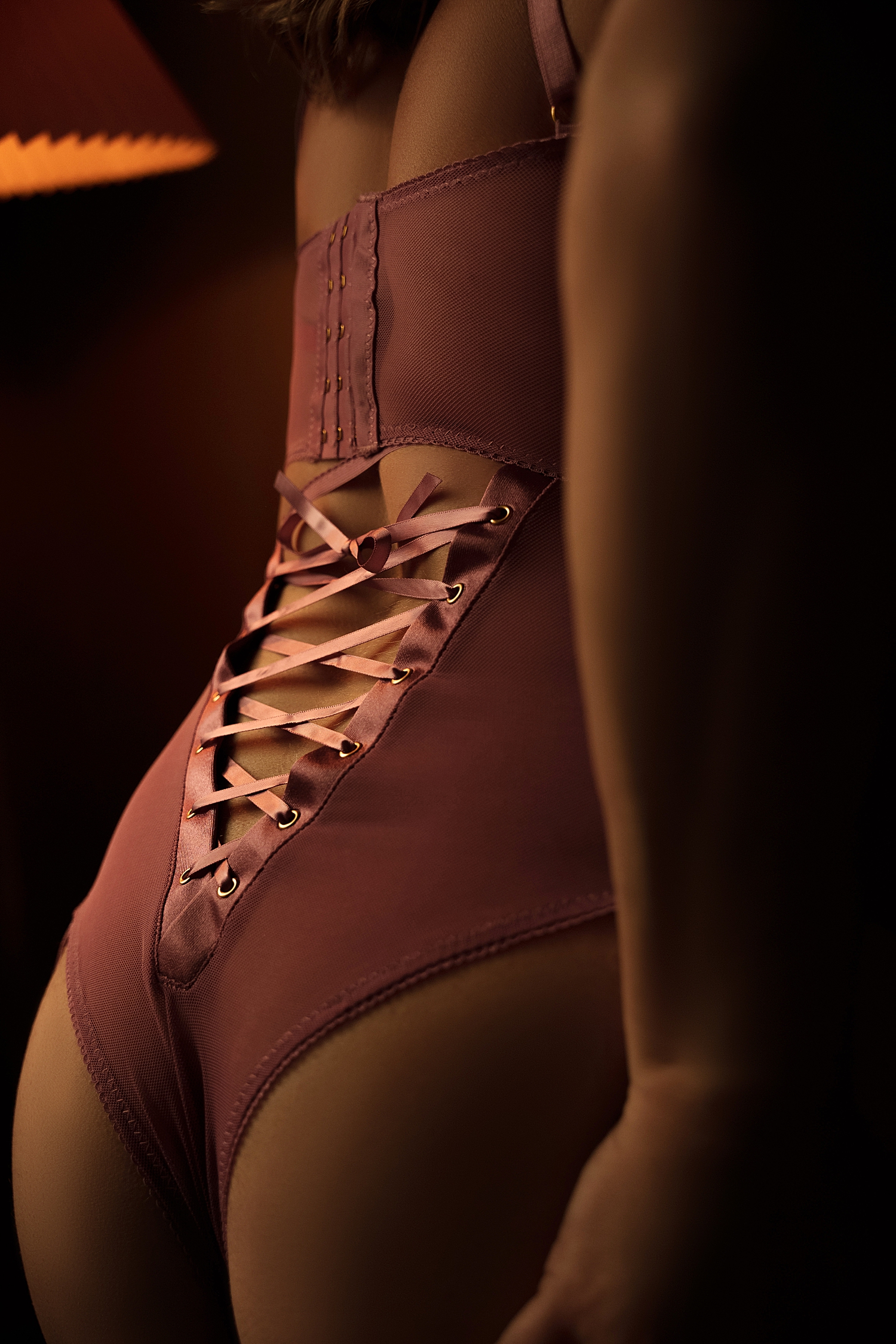 woman in lace up corset by Emma Christine Photography