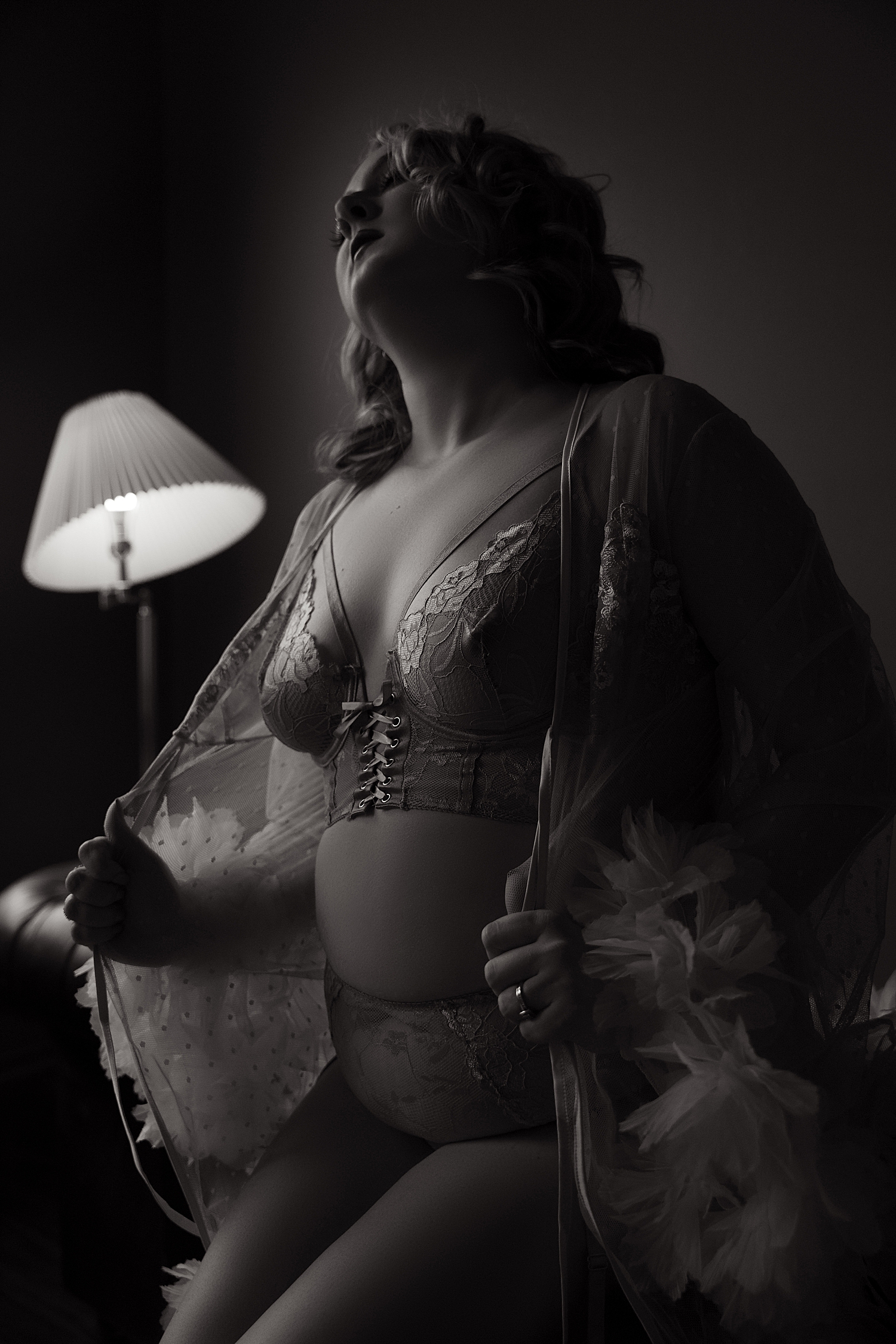 model in lace bralette in low lighting by Sioux Falls boudoir photographer