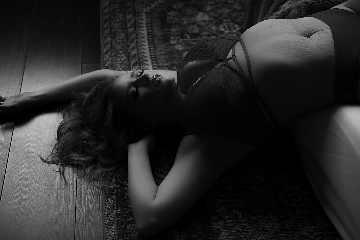 mom with stretch marks leans back in bralette by Sioux Falls boudoir photographer