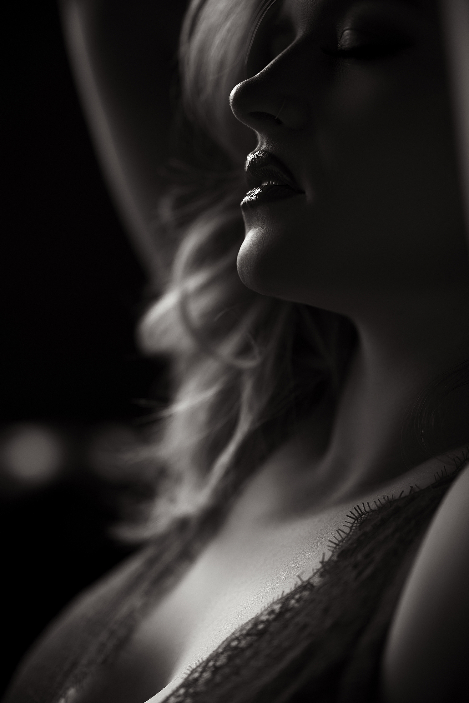 blonde in red lingerie leans back in studio for photos