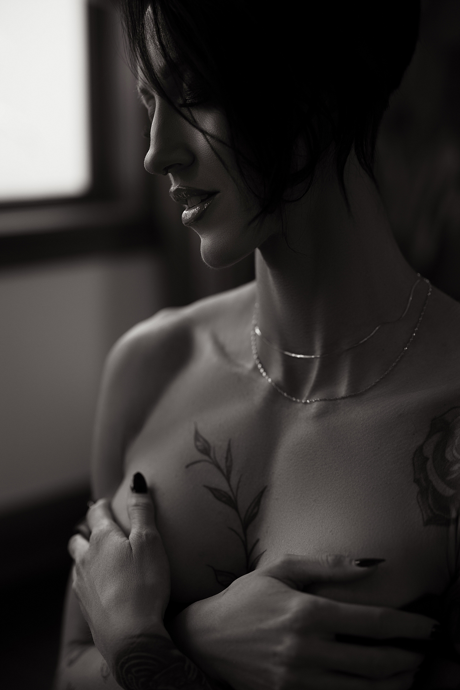 brunette with short hair in lingerie on bed by Sioux Falls Boudoir Photographer