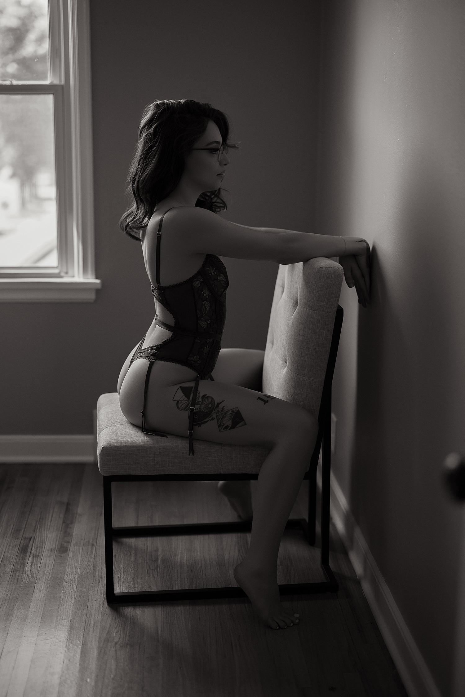 woman in lingerie bodysuit straddles chair showing why posing matters